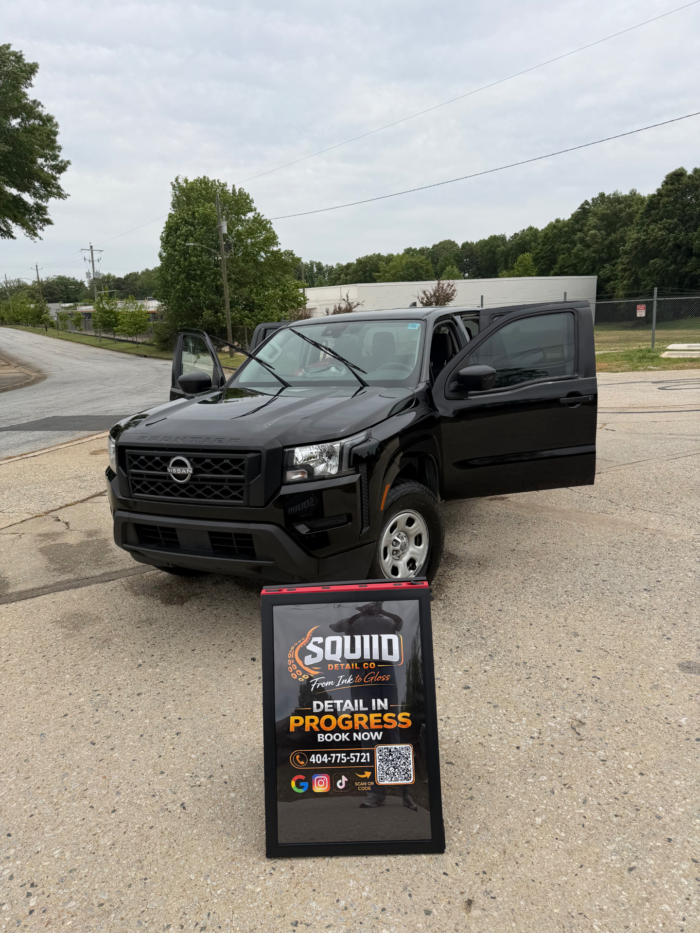 Squiid Detail Co truck on-site with Detail In Progress sign