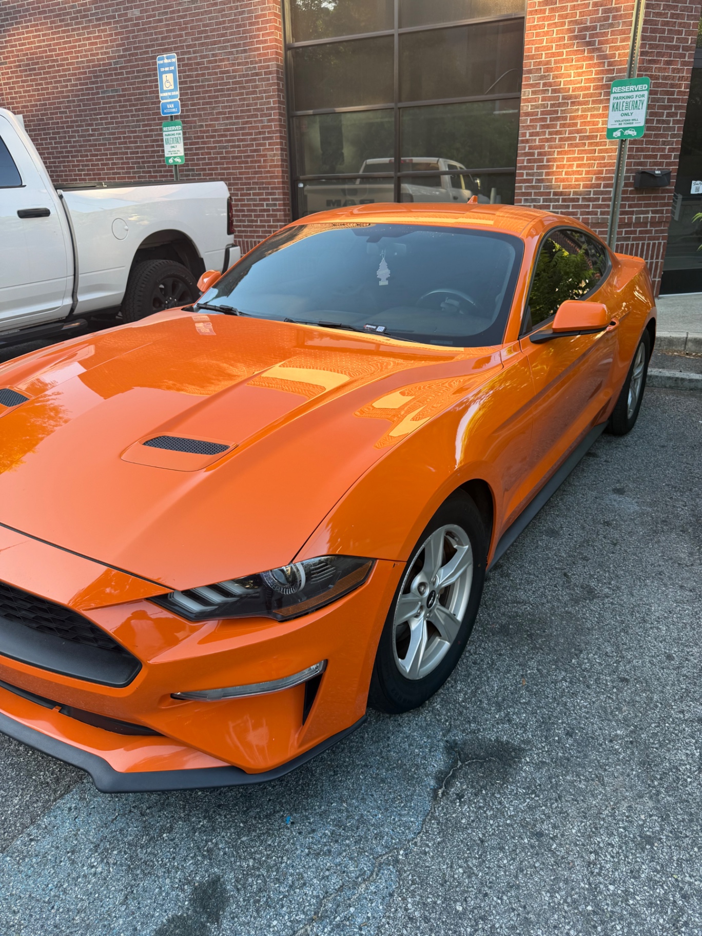 Orange Ford Mustang reflecting a fresh gloss finish